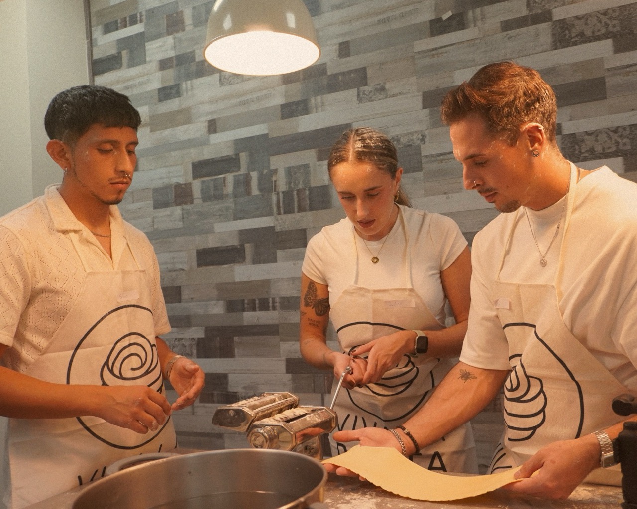 A couple smiling while learning to cook.